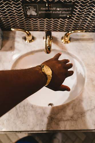 sink person about to hold faucet in a sink new york
